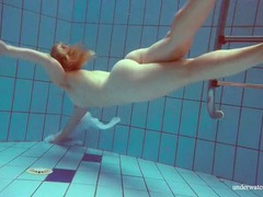 JerkMania presents: Redhead goes for a nude swim in the pool